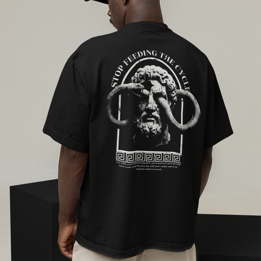 Person wearing a black t-shirt with a graphic design on the back, standing against a plain background.